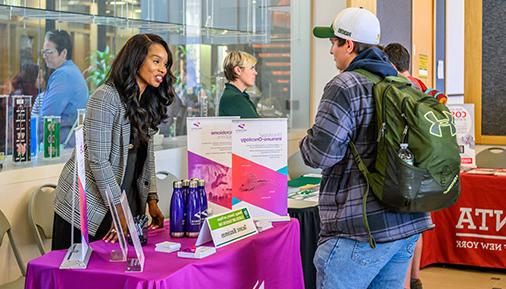 Student and vendor at Biology, Chemistry and Physics Career Fair